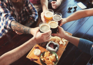 Photo of Four People Toasting at One of the Best Vermont Breweries