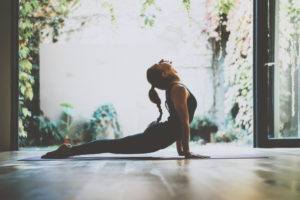 Photo of Young Woman Practiving Yoga During a Wellness Retreat in New England.