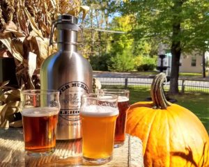 Photo from the Vermont Brewery Tour at The Norwich Inn, including Beer, a Growler, and a Pumpkin.