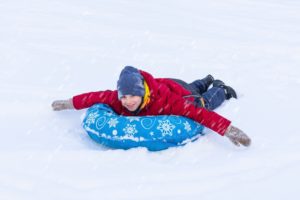A child snow tubing in Vermont.