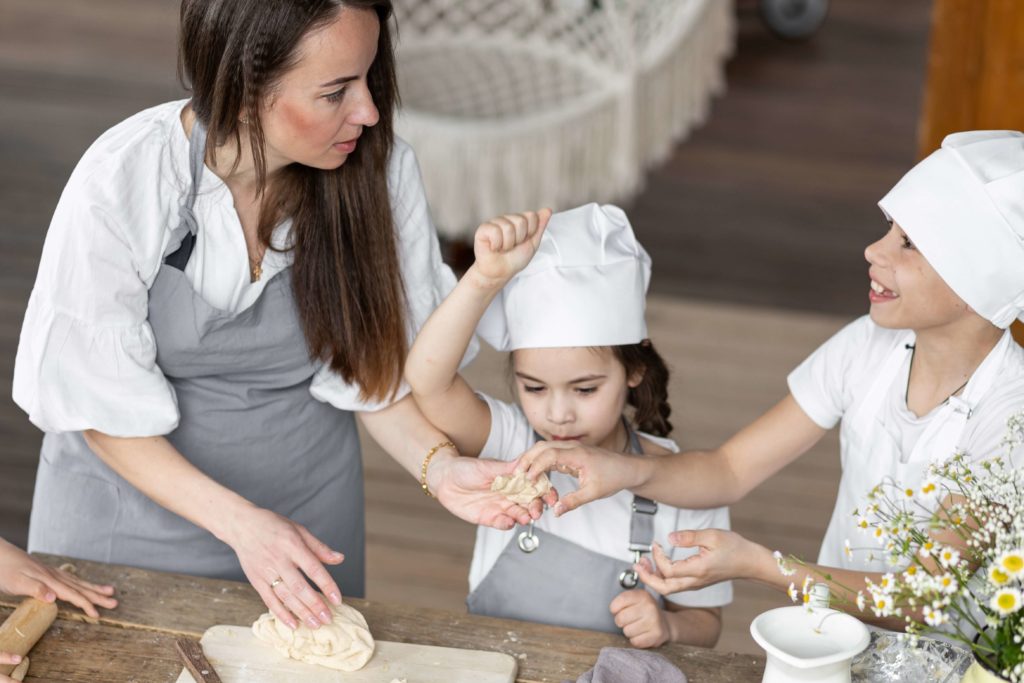 A woman and two children baking like what they could do at King Arthur Baking Company in Vermont.