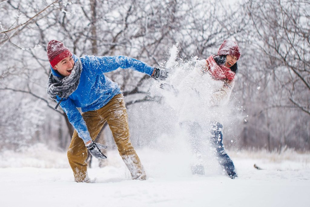 A man and a woman enjoying All Things Upper Valley in the snow.