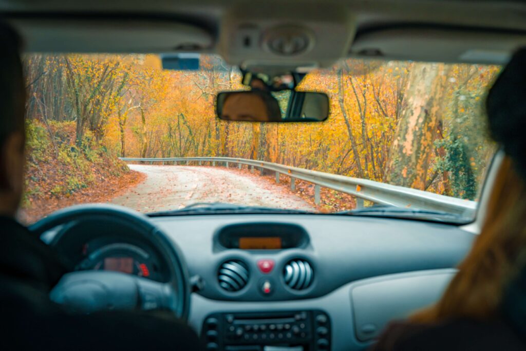 Two people in a car on a New England Roadtrip.