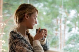 A woman with coffee enjoying Things To Do In Hanover.
